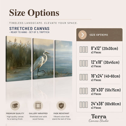 A white heron beside tall marsh grasses and still blue water 3 piece canvas wall art available dimensions; triptych dimensions are per panel