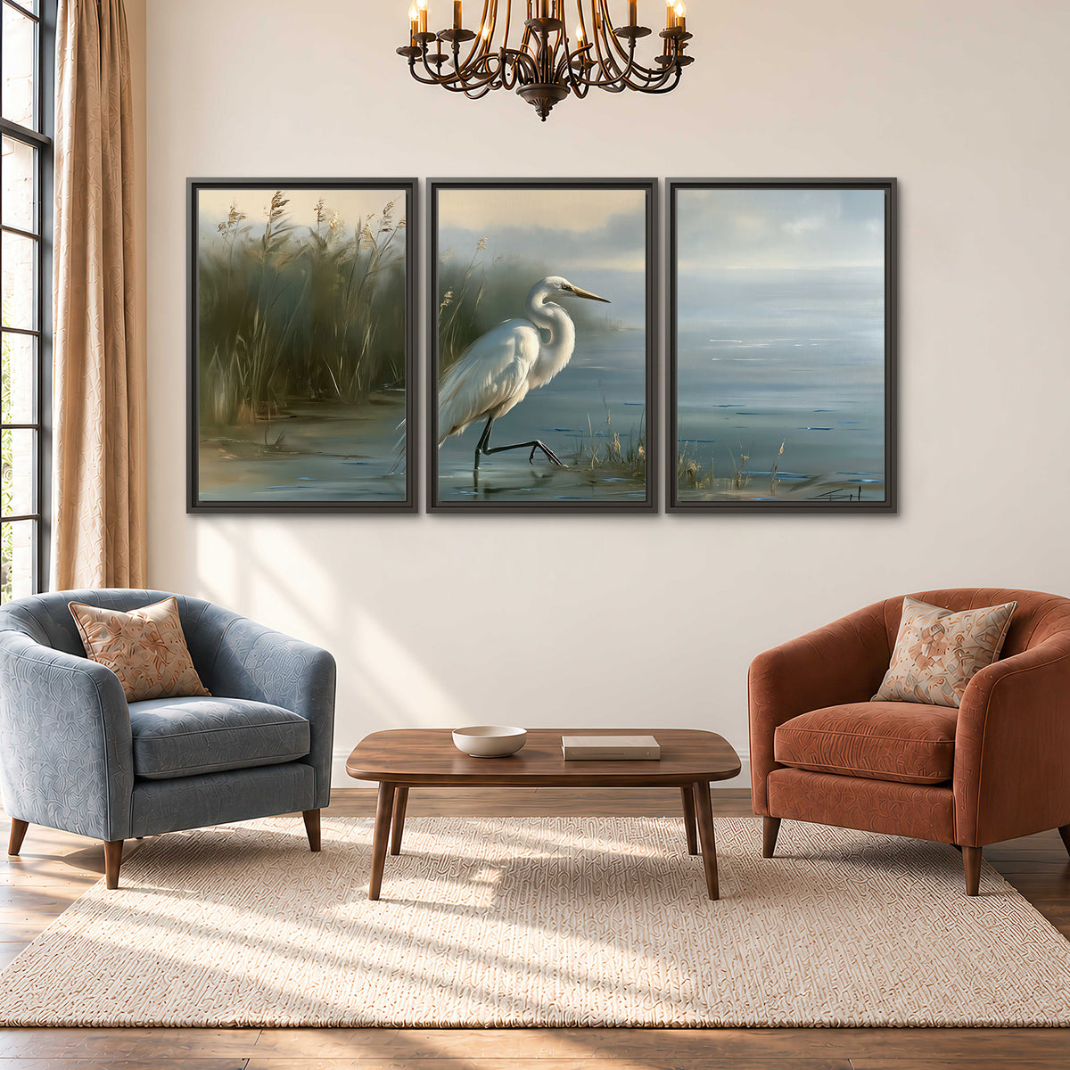 A white heron beside tall marsh grasses and still blue water 3 piece framed canvas wall art styled in an interior
