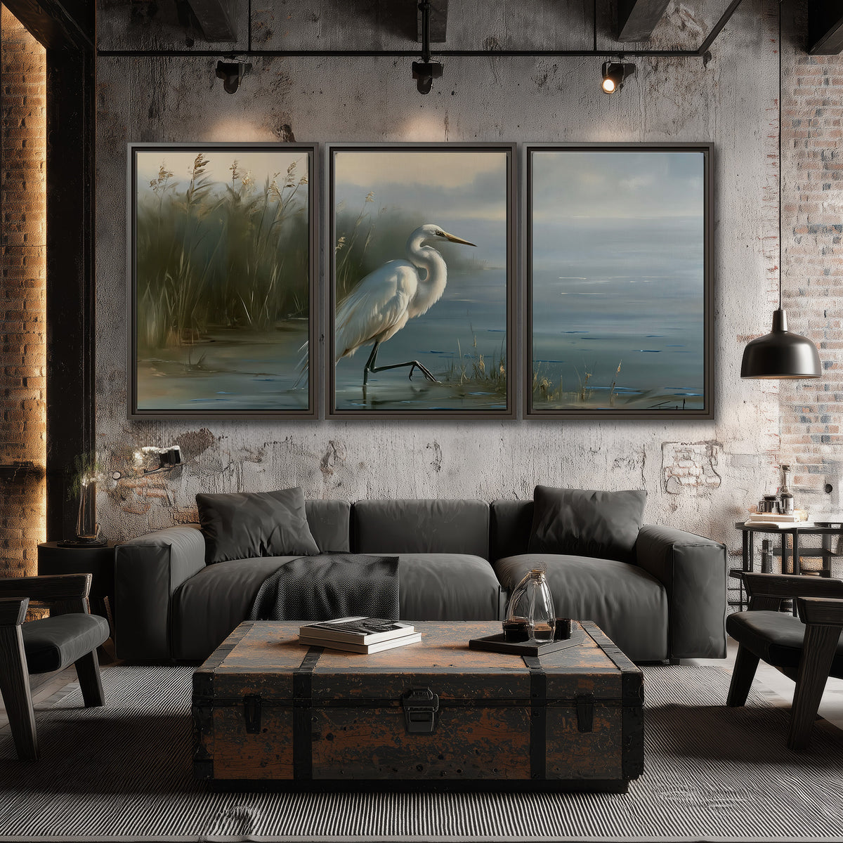 A white heron beside tall marsh grasses and still blue water 3 piece framed canvas wall art displayed in a industrial room