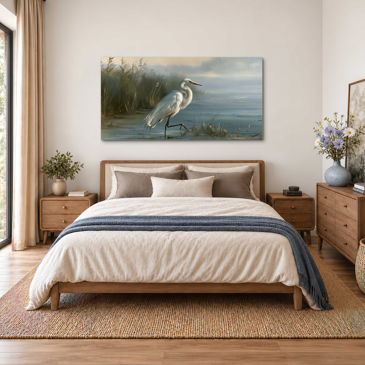 A white heron beside tall marsh grasses and still blue water single canvas wall art styled in an interior