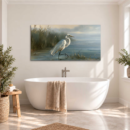 A white heron beside tall marsh grasses and still blue water single canvas wall art styled in an interior