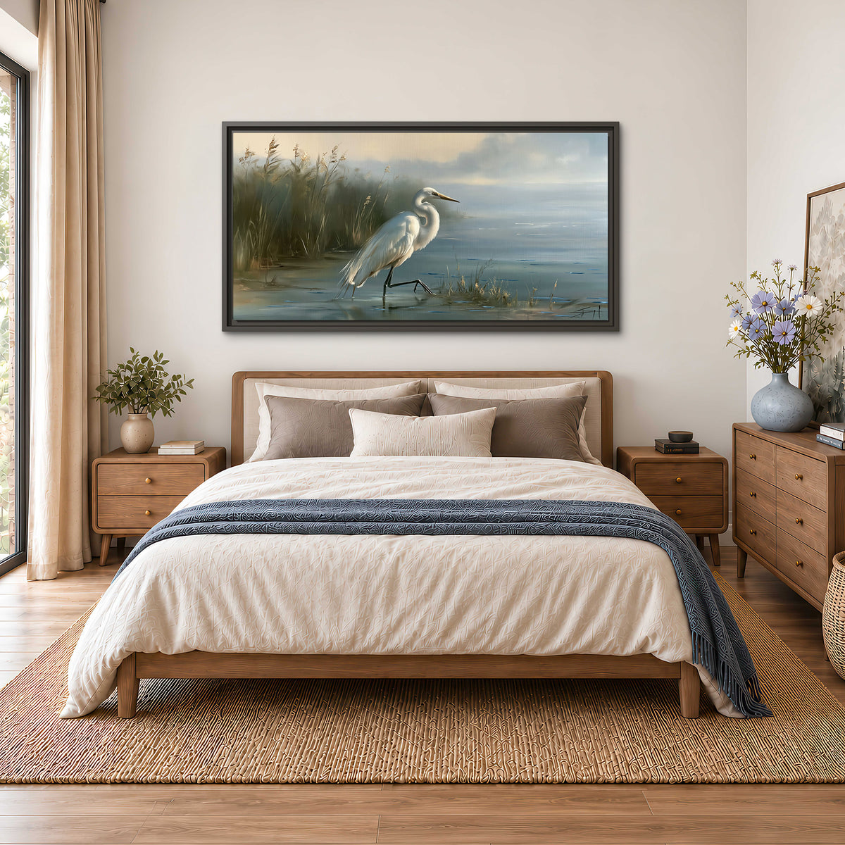 A white heron beside tall marsh grasses and still blue water single framed canvas wall art styled in an interior