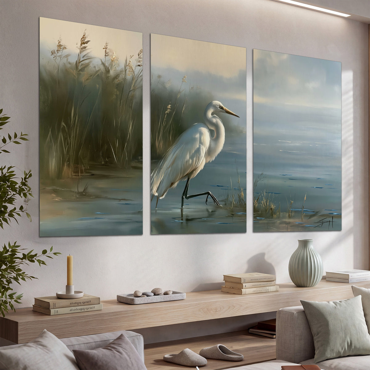 A white heron beside tall marsh grasses and still blue water set of 3 poster prints displayed in a console