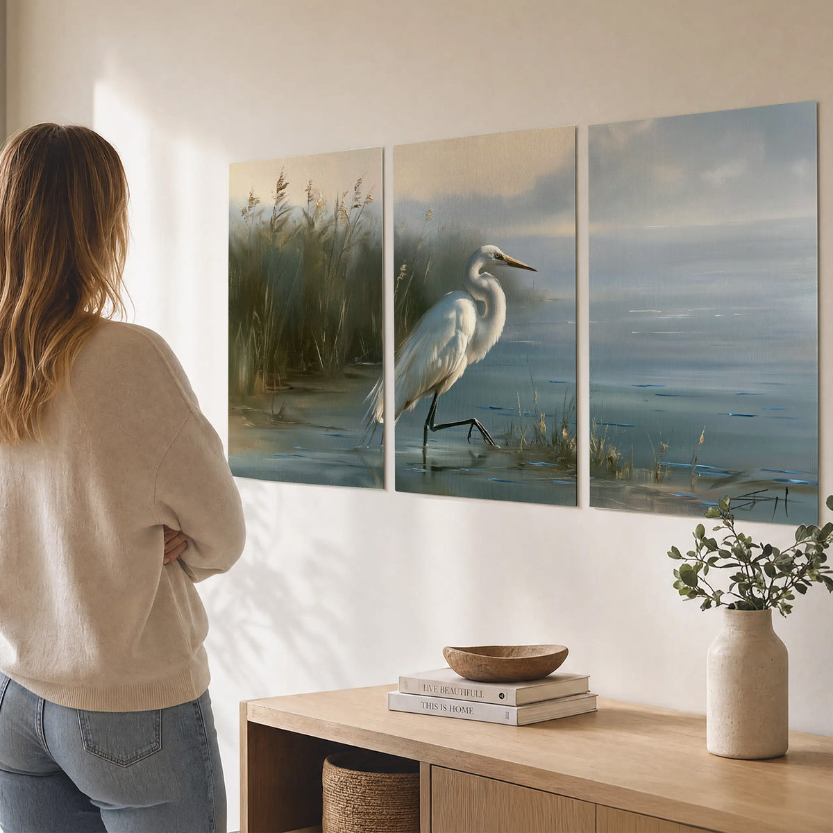 A white heron beside tall marsh grasses and still blue water set of 3 poster prints three panel arrangement on a wall