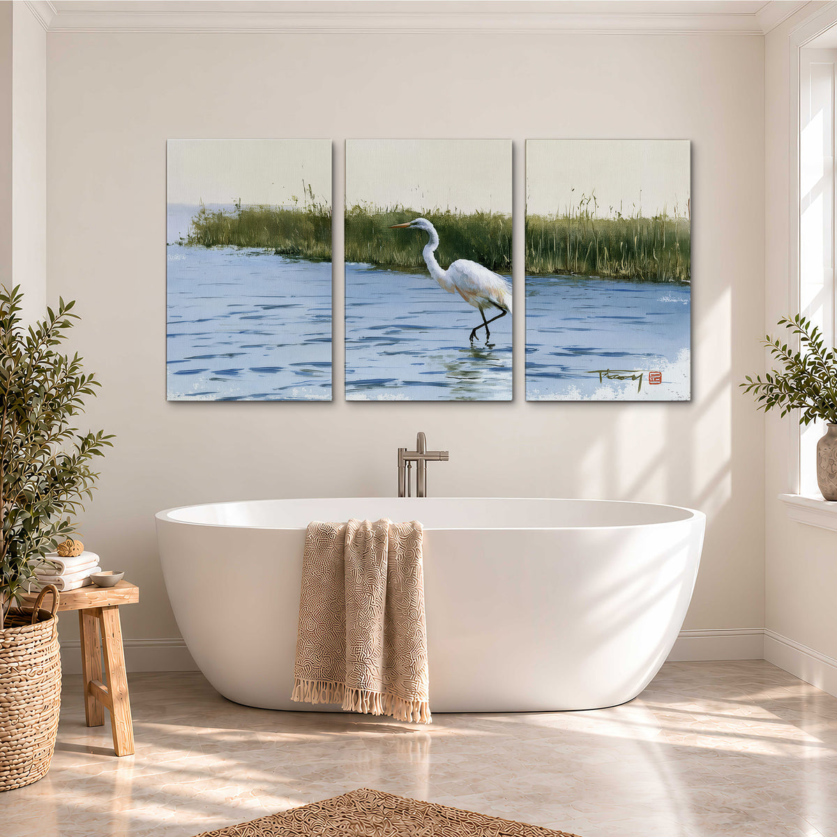 A white heron wading through bright blue water beside green reeds 3 piece canvas wall art styled in an interior