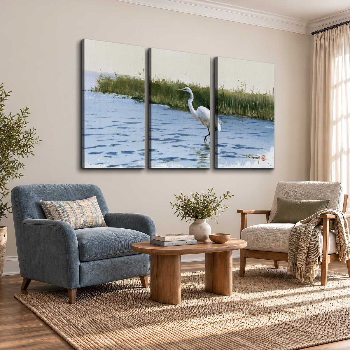 A white heron wading through bright blue water beside green reeds 3 piece canvas wall art styled in an interior