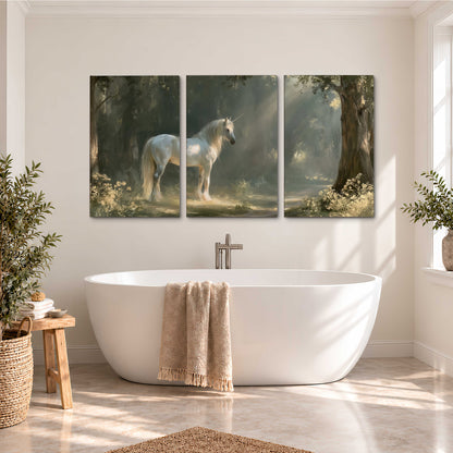 A white unicorn standing beneath arching trees in a softly lit woodland 3 piece canvas wall art styled in an interior