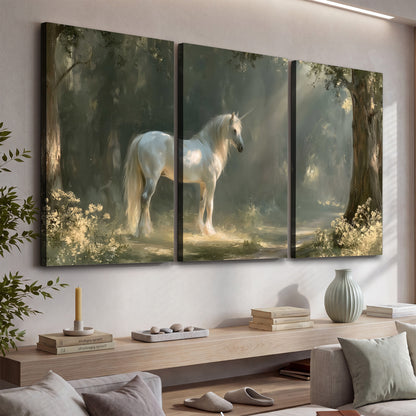 A white unicorn standing beneath arching trees in a softly lit woodland 3 piece canvas wall art displayed in a console