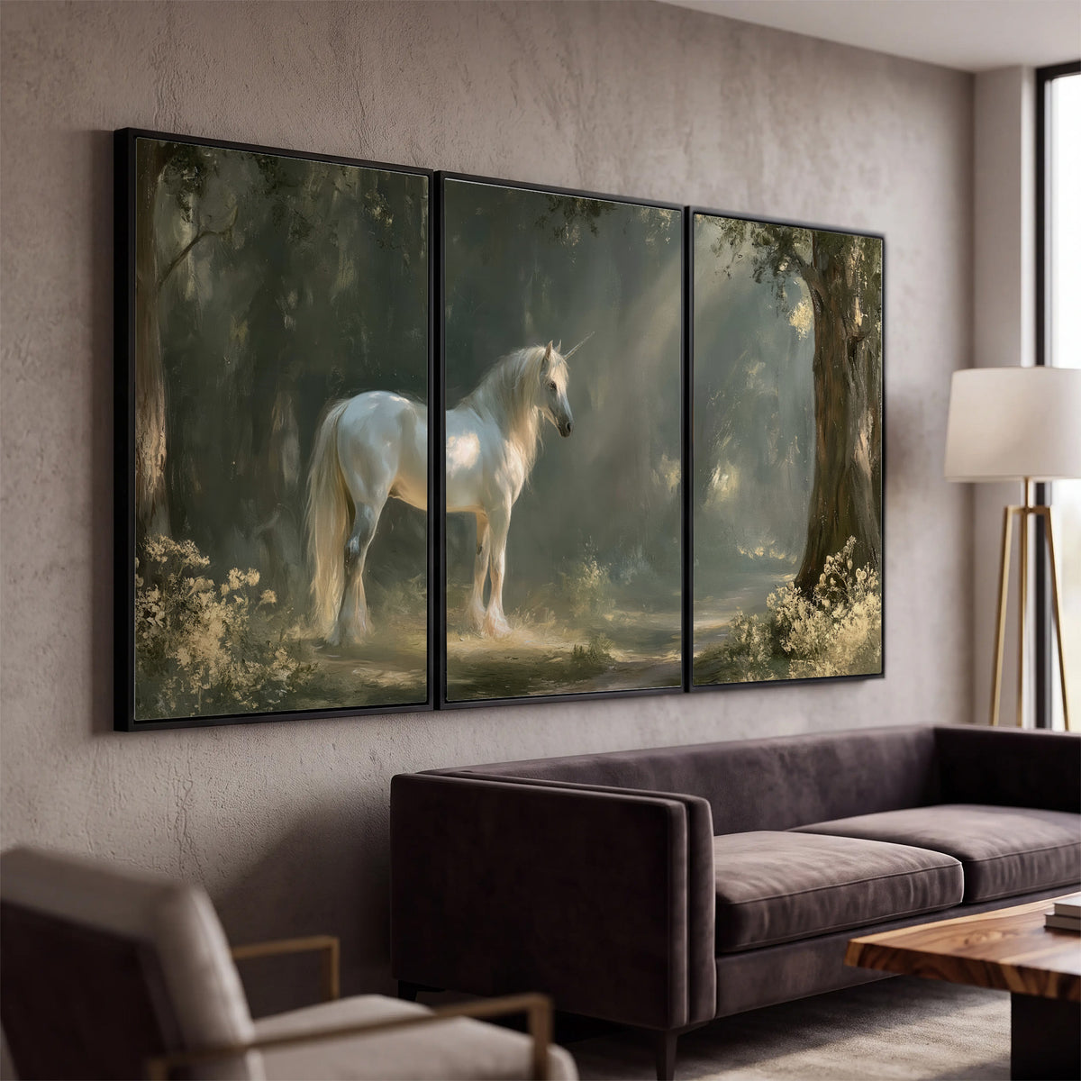 A white unicorn standing beneath arching trees in a softly lit woodland 3 piece framed canvas wall art displayed in a modern living room