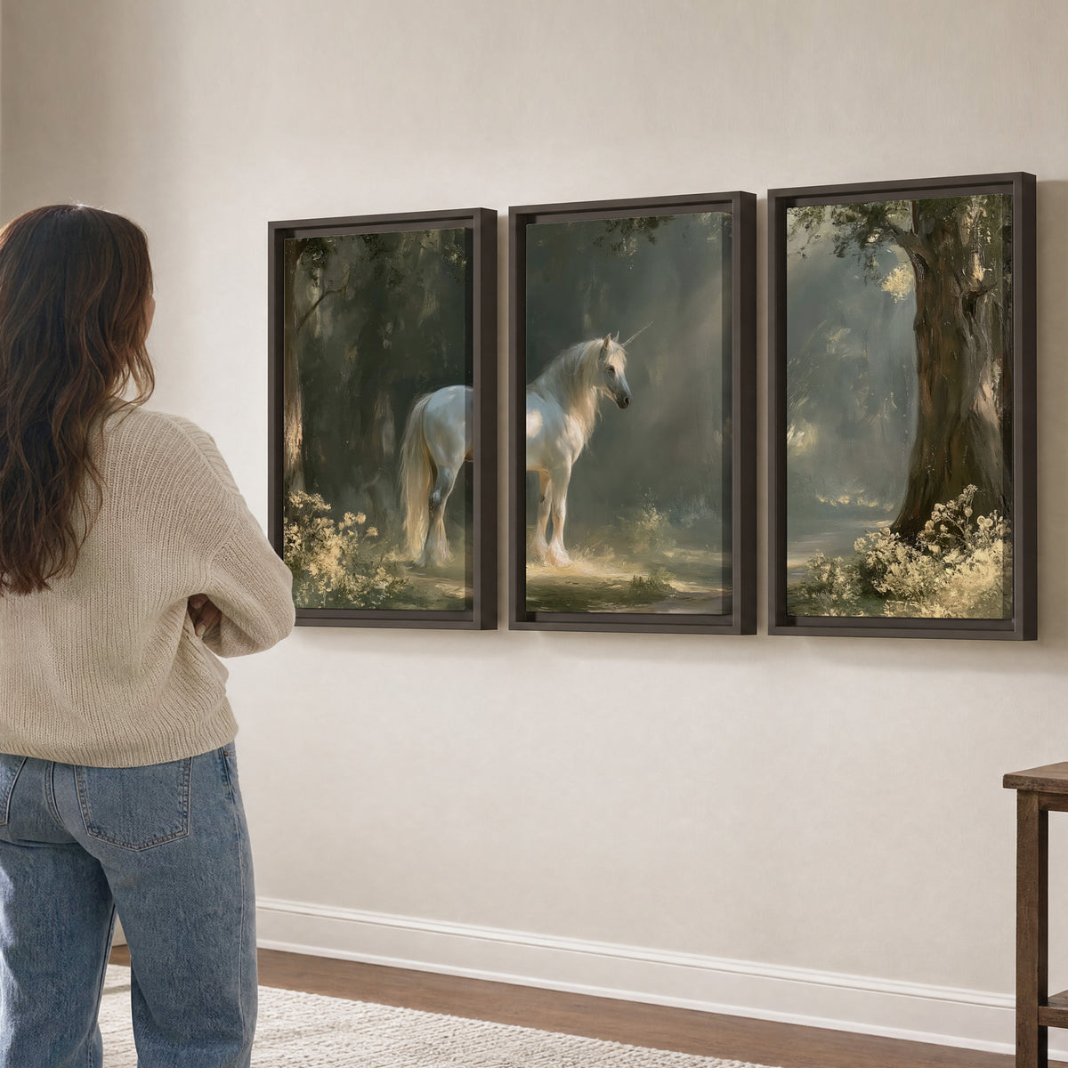 A white unicorn standing beneath arching trees in a softly lit woodland 3 piece framed canvas wall art three panel arrangement on a wall