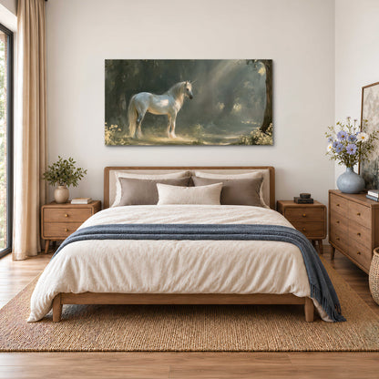 A white unicorn standing beneath arching trees in a softly lit woodland single canvas wall art styled in an interior