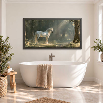 A white unicorn standing beneath arching trees in a softly lit woodland single framed canvas wall art styled in an interior