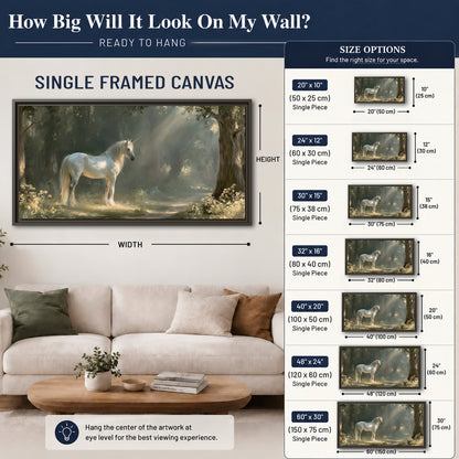 A white unicorn standing beneath arching trees in a softly lit woodland single framed canvas wall art size guide above a sofa; room view is illustrative