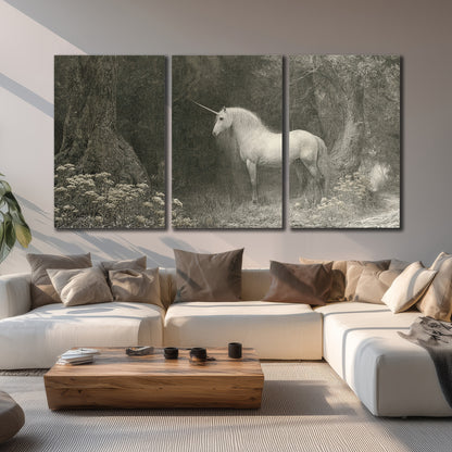 A pale unicorn surrounded by fine gray woodland branches and soft mist 3 piece canvas wall art displayed in a living room