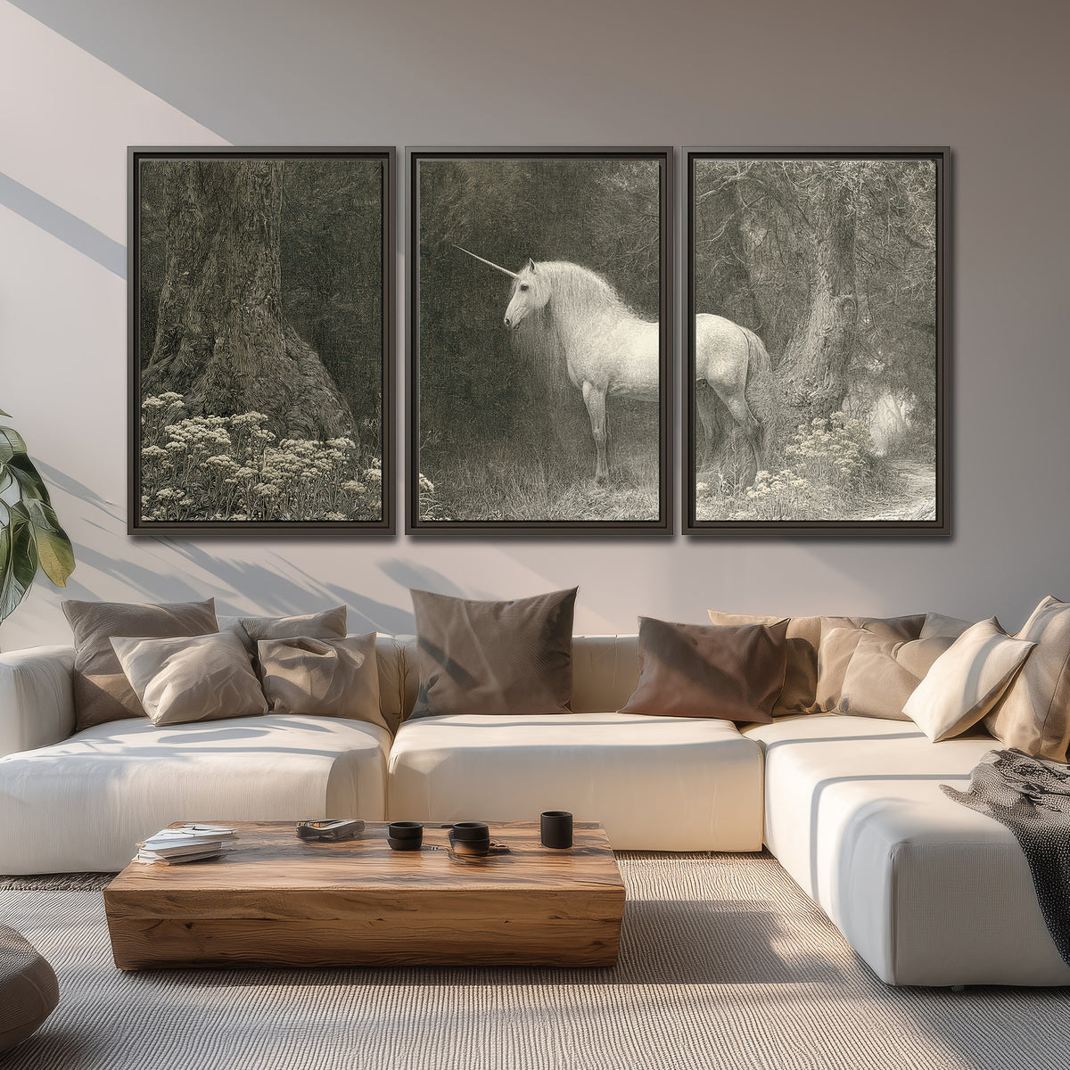 A pale unicorn surrounded by fine gray woodland branches and soft mist 3 piece framed canvas wall art displayed in a living room