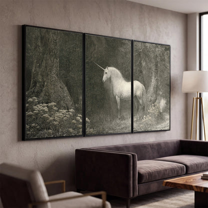 A pale unicorn surrounded by fine gray woodland branches and soft mist 3 piece framed canvas wall art displayed in a modern living room