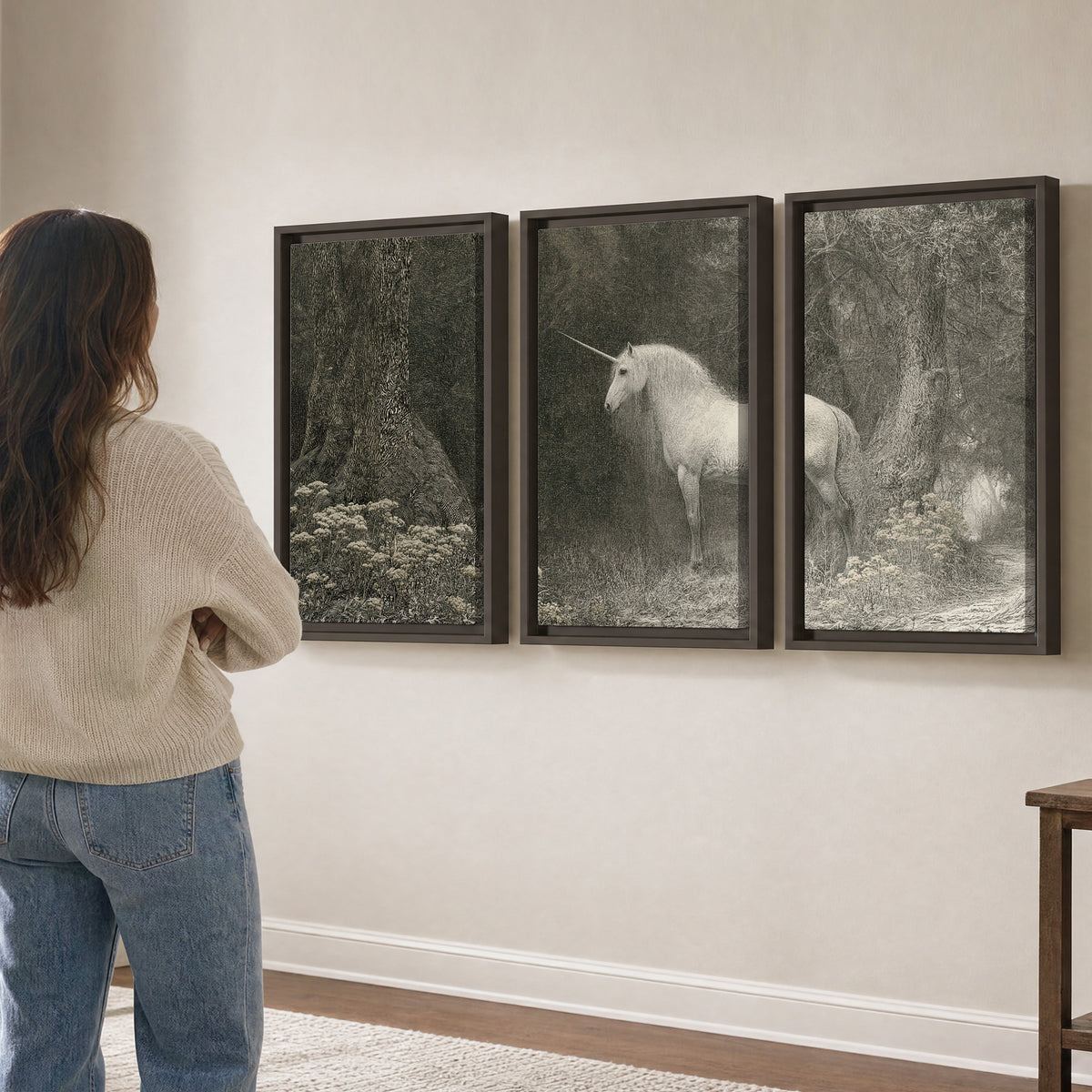 A pale unicorn surrounded by fine gray woodland branches and soft mist 3 piece framed canvas wall art three panel arrangement on a wall