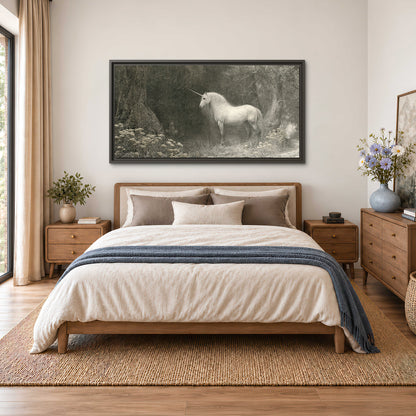 A pale unicorn surrounded by fine gray woodland branches and soft mist single framed canvas wall art styled in an interior
