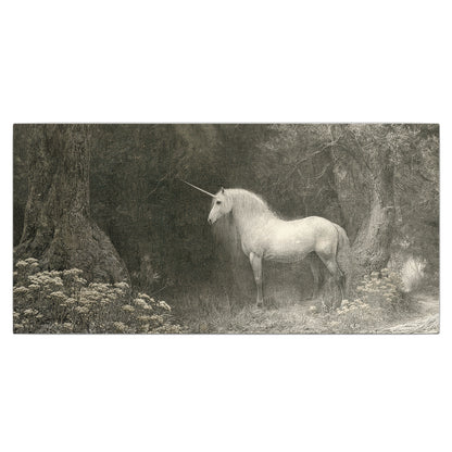 A pale unicorn surrounded by fine gray woodland branches and soft mist single canvas wall art viewed straight on
