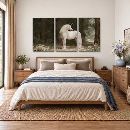 A white unicorn standing in a shadowed forest clearing among dark tree trunks 3 piece canvas wall art styled in an interior