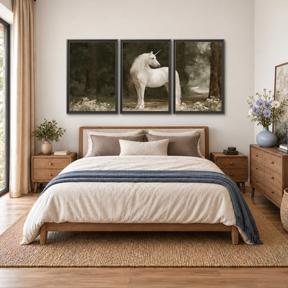 A white unicorn standing in a shadowed forest clearing among dark tree trunks 3 piece framed canvas wall art styled in an interior