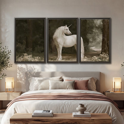 A white unicorn standing in a shadowed forest clearing among dark tree trunks 3 piece framed canvas wall art displayed in a bedroom