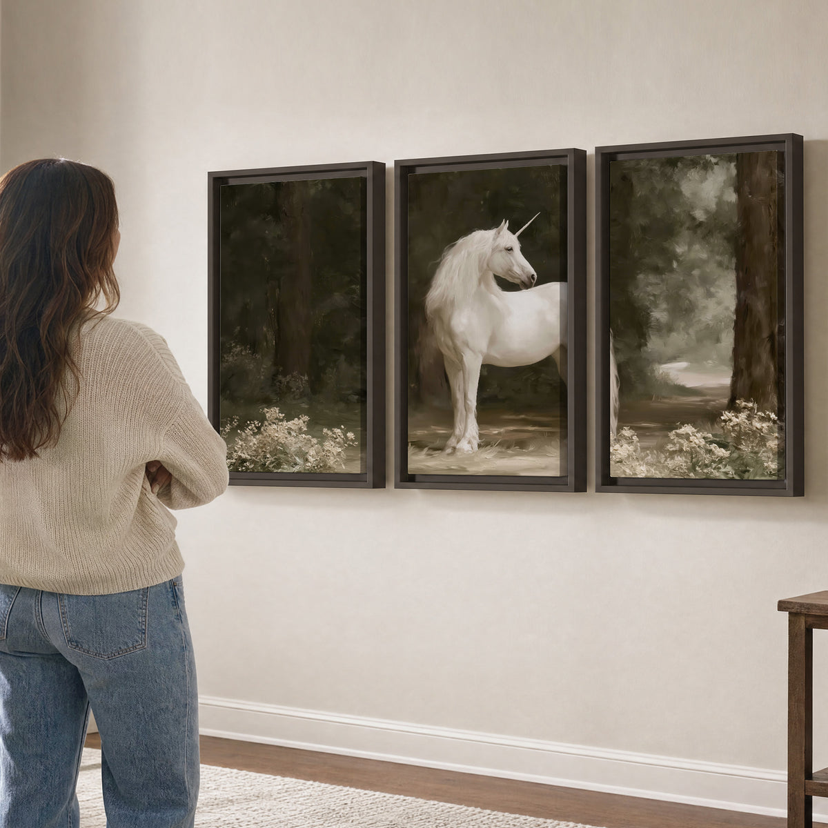 A white unicorn standing in a shadowed forest clearing among dark tree trunks 3 piece framed canvas wall art three panel arrangement on a wall