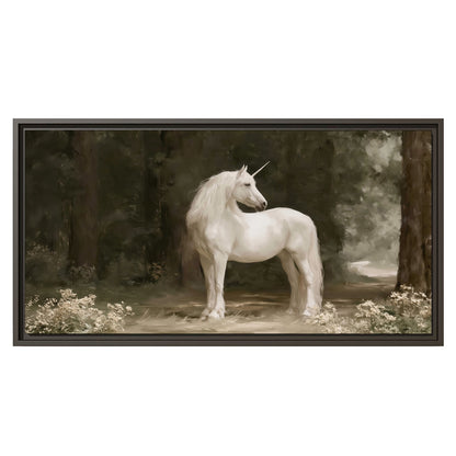A white unicorn standing in a shadowed forest clearing among dark tree trunks single framed canvas wall art viewed straight on