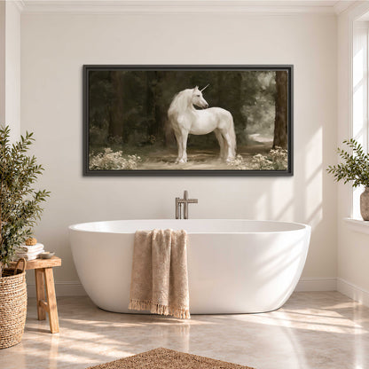 A white unicorn standing in a shadowed forest clearing among dark tree trunks single framed canvas wall art styled in an interior