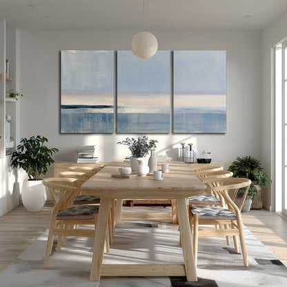 A minimal blue seascape with a pale horizon and soft vertical reflections 3 piece canvas wall art room and product view