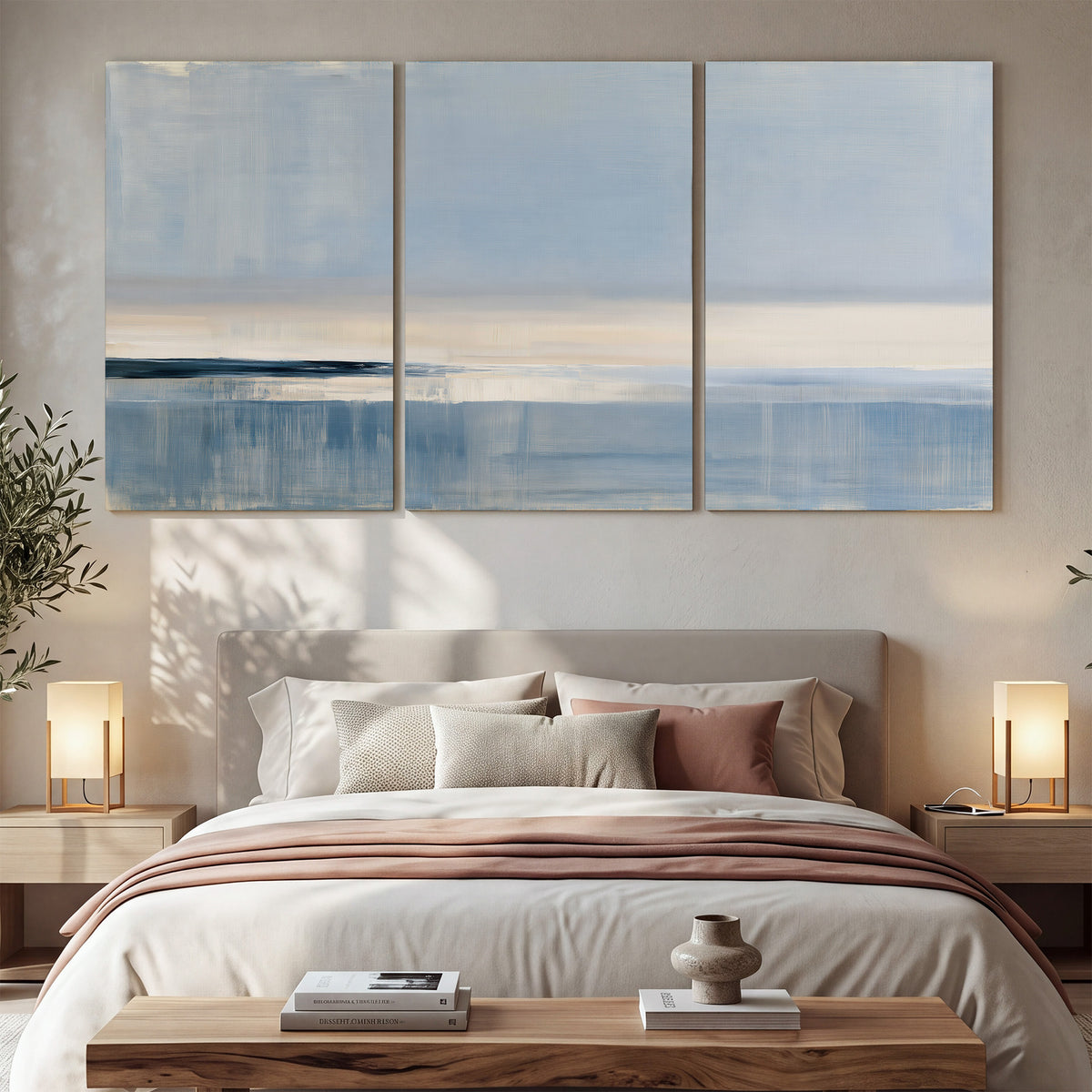 A minimal blue seascape with a pale horizon and soft vertical reflections 3 piece canvas wall art displayed in a bedroom
