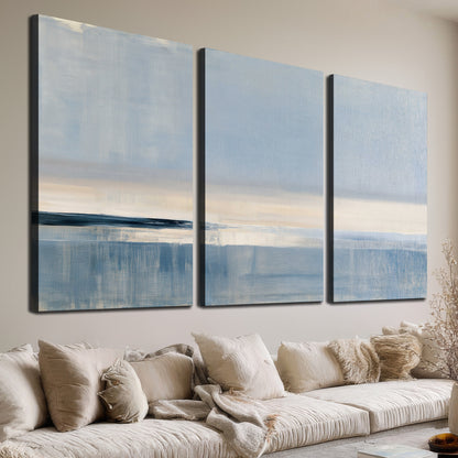 A minimal blue seascape with a pale horizon and soft vertical reflections 3 piece canvas wall art room and product view