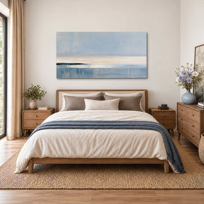 A minimal blue seascape with a pale horizon and soft vertical reflections single canvas wall art styled in an interior