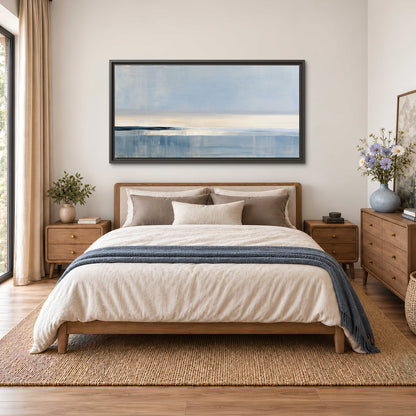 A minimal blue seascape with a pale horizon and soft vertical reflections single framed canvas wall art styled in an interior