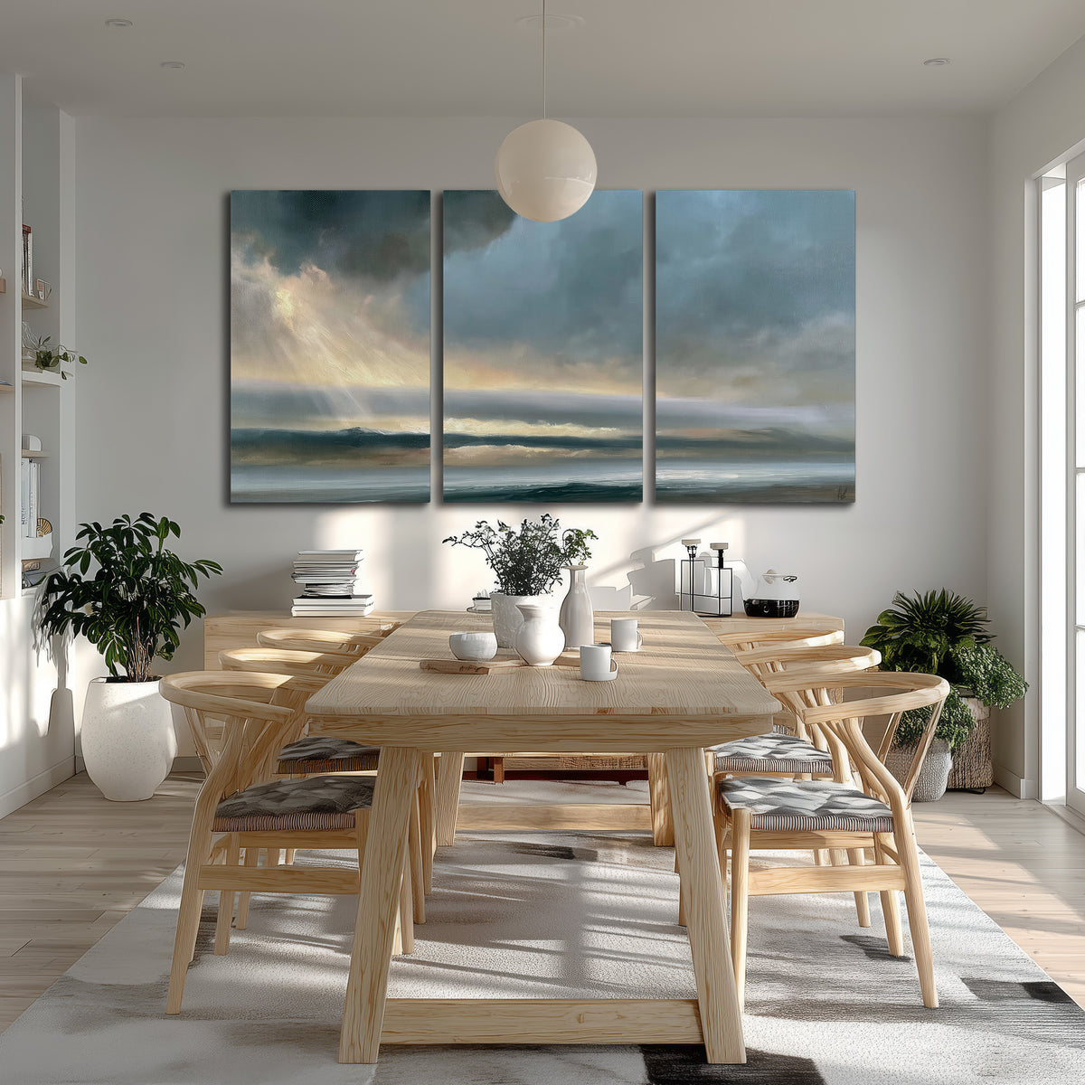 Dramatic blue-gray storm clouds breaking over a pale strip of ocean light 3 piece canvas wall art room and product view