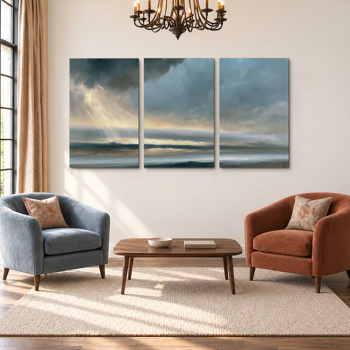 Dramatic blue-gray storm clouds breaking over a pale strip of ocean light 3 piece canvas wall art styled in an interior