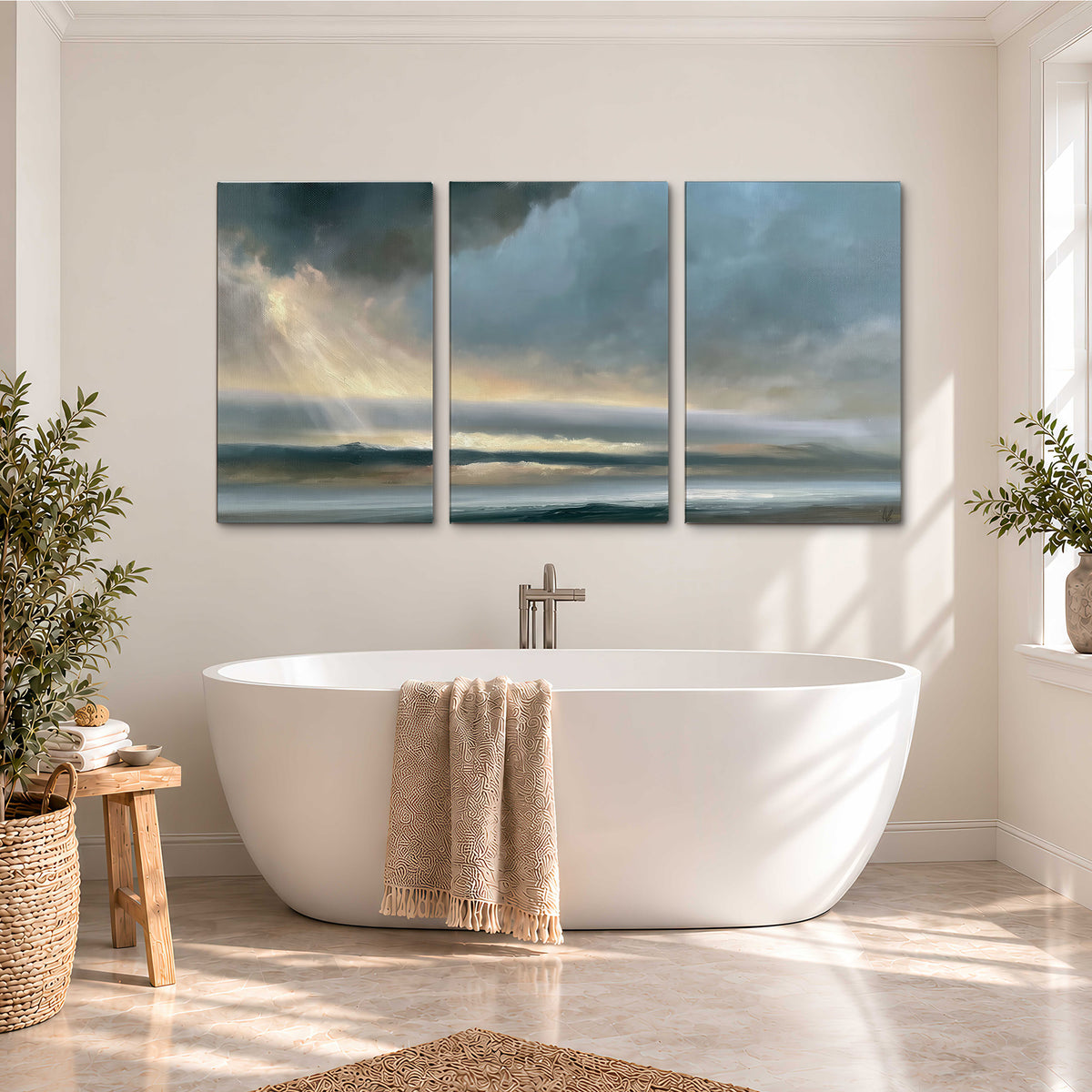 Dramatic blue-gray storm clouds breaking over a pale strip of ocean light 3 piece canvas wall art styled in an interior
