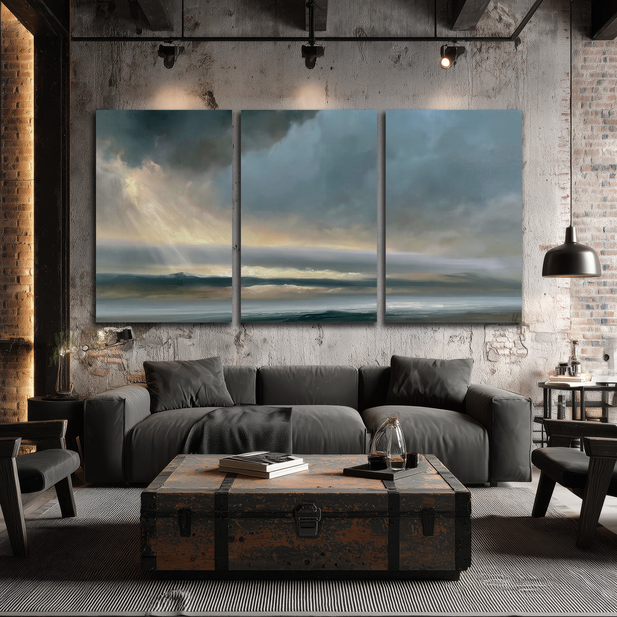 Dramatic blue-gray storm clouds breaking over a pale strip of ocean light 3 piece canvas wall art displayed in a industrial room