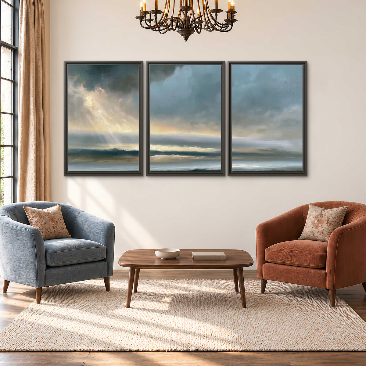 Dramatic blue-gray storm clouds breaking over a pale strip of ocean light 3 piece framed canvas wall art styled in an interior