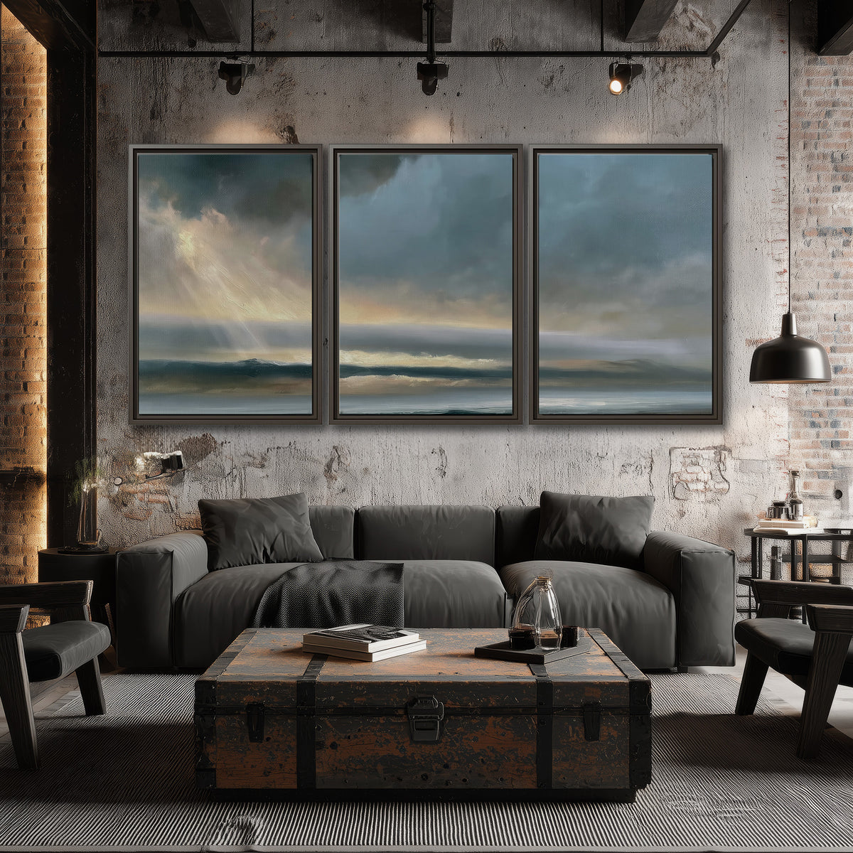 Dramatic blue-gray storm clouds breaking over a pale strip of ocean light 3 piece framed canvas wall art displayed in a industrial room