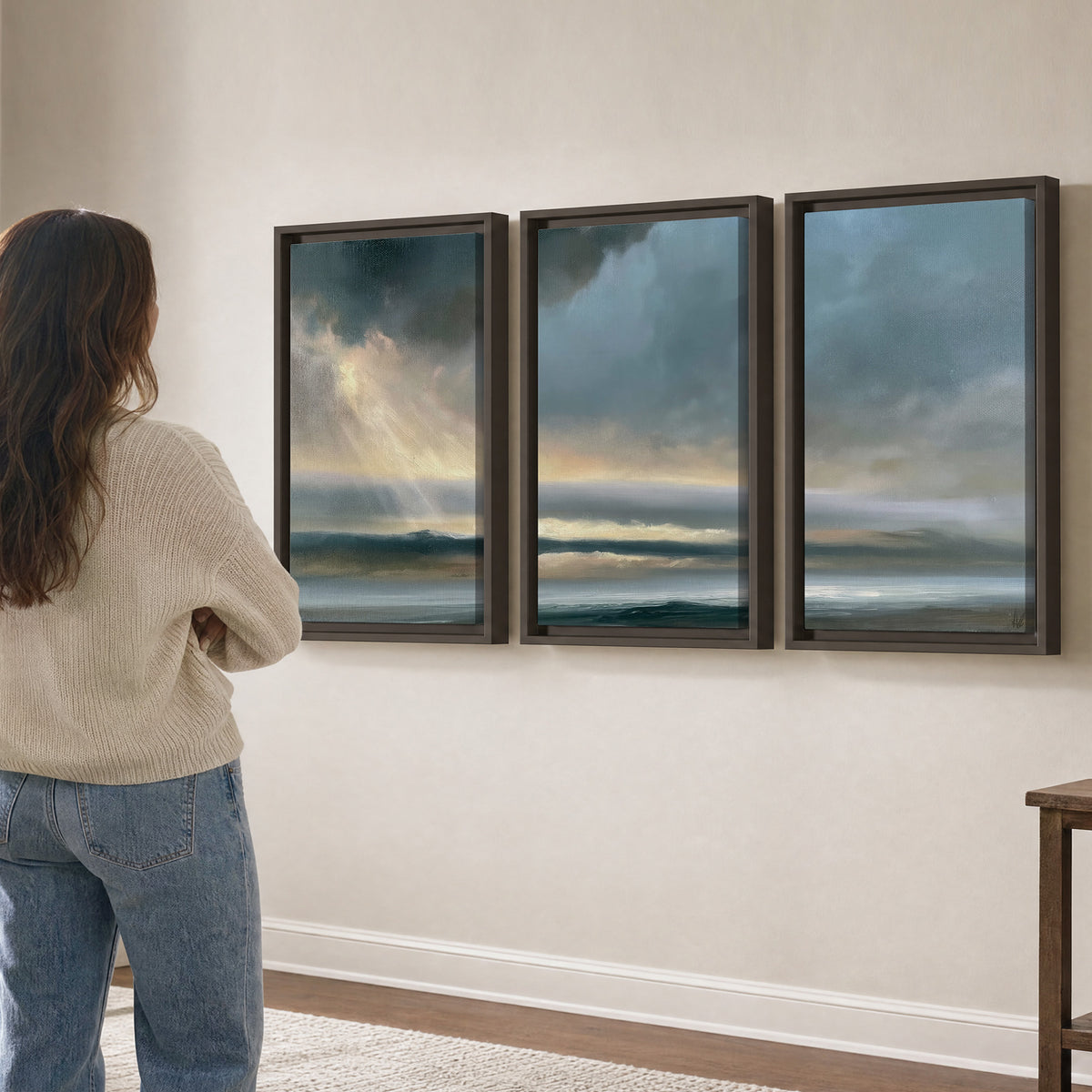 Dramatic blue-gray storm clouds breaking over a pale strip of ocean light 3 piece framed canvas wall art three panel arrangement on a wall