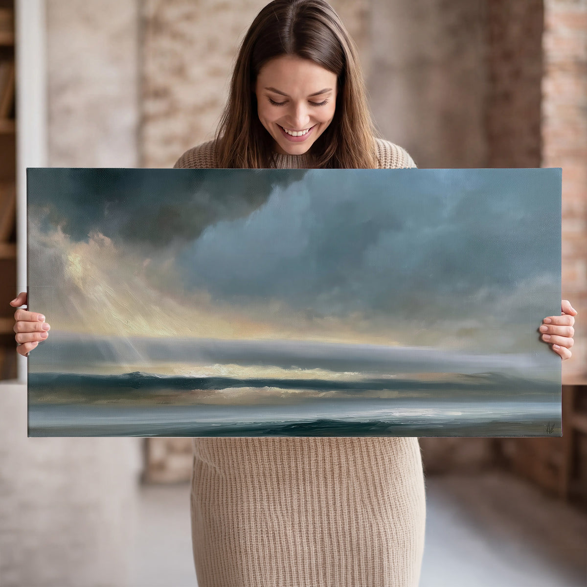 Dramatic blue-gray storm clouds breaking over a pale strip of ocean light single canvas wall art held in hands