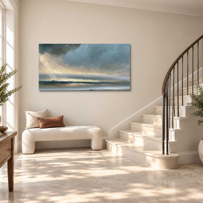 Dramatic blue-gray storm clouds breaking over a pale strip of ocean light single canvas wall art styled in an interior
