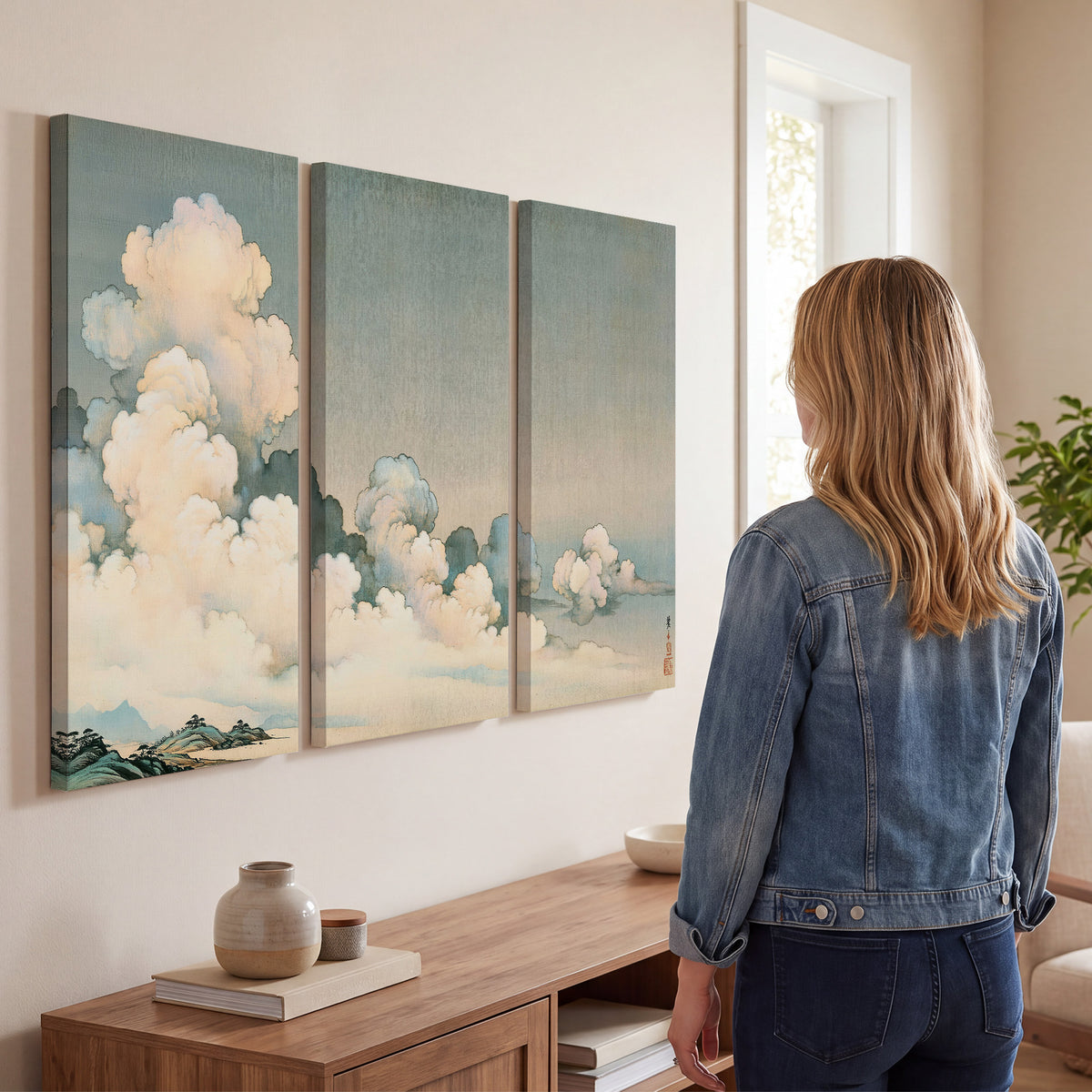 Soft cream clouds gathered low in a muted blue-green sky 3 piece canvas wall art three panel arrangement on a wall