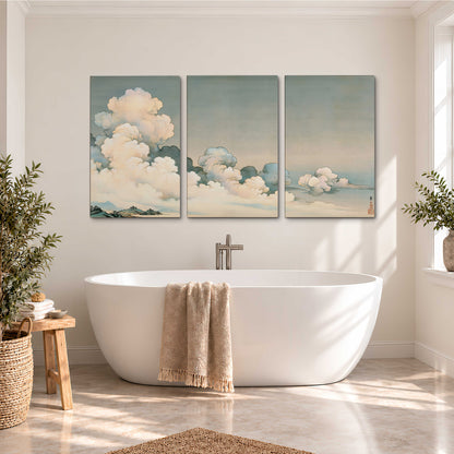 Soft cream clouds gathered low in a muted blue-green sky 3 piece canvas wall art styled in an interior
