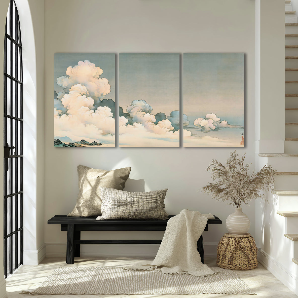 Soft cream clouds gathered low in a muted blue-green sky 3 piece canvas wall art displayed in a entryway