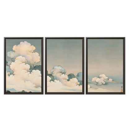 Soft cream clouds gathered low in a muted blue-green sky 3 piece framed canvas wall art viewed straight on