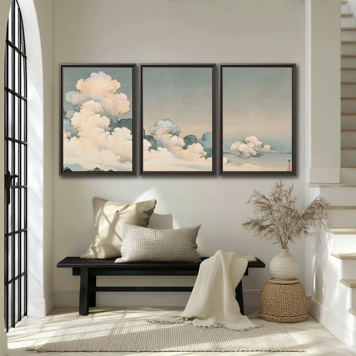 Soft cream clouds gathered low in a muted blue-green sky 3 piece framed canvas wall art displayed in a entryway