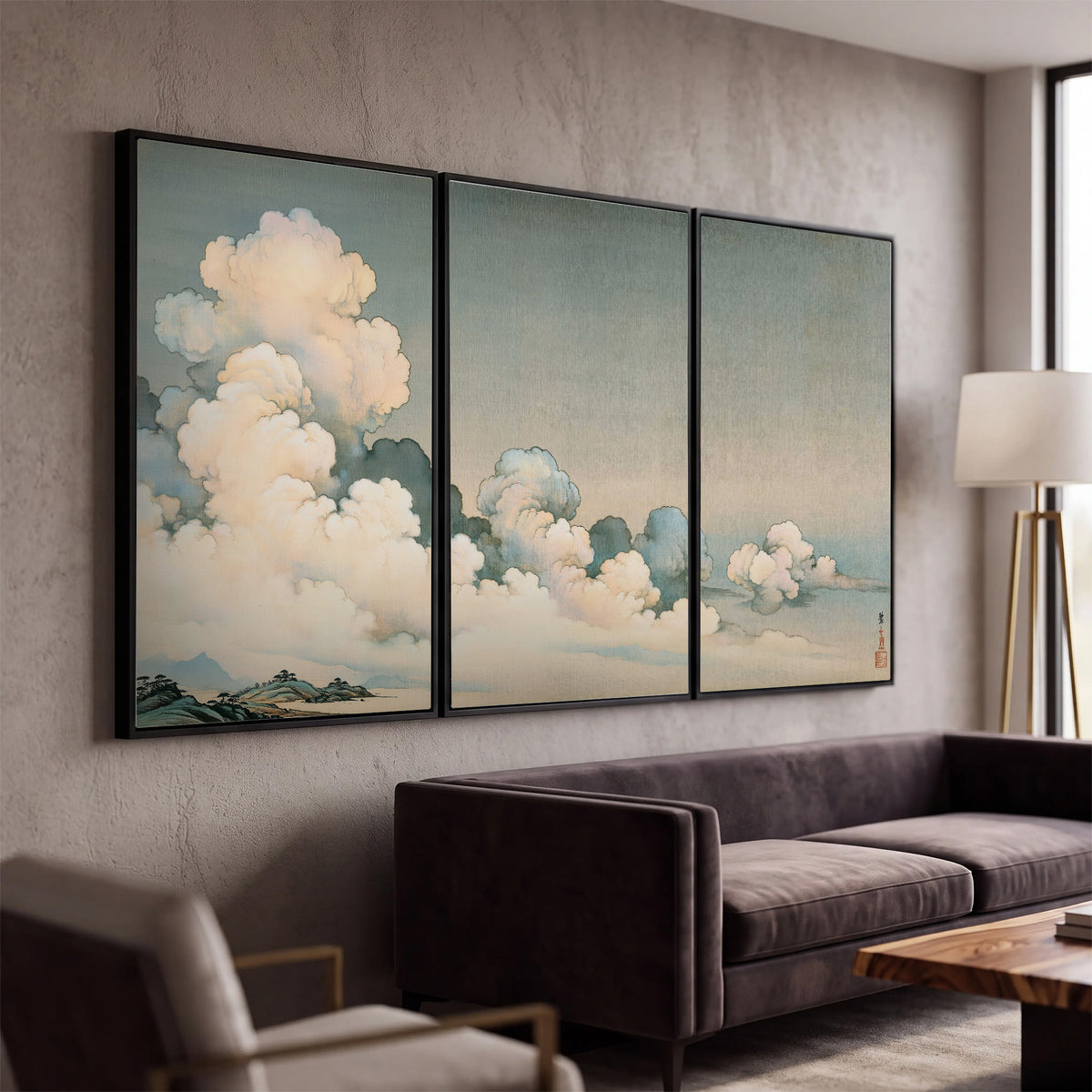 Soft cream clouds gathered low in a muted blue-green sky 3 piece framed canvas wall art displayed in a modern living room