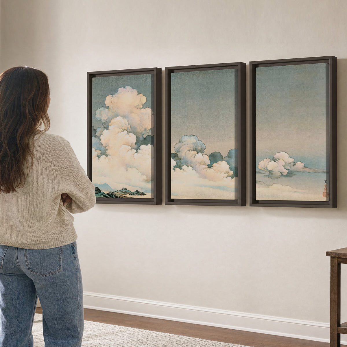 Soft cream clouds gathered low in a muted blue-green sky 3 piece framed canvas wall art three panel arrangement on a wall